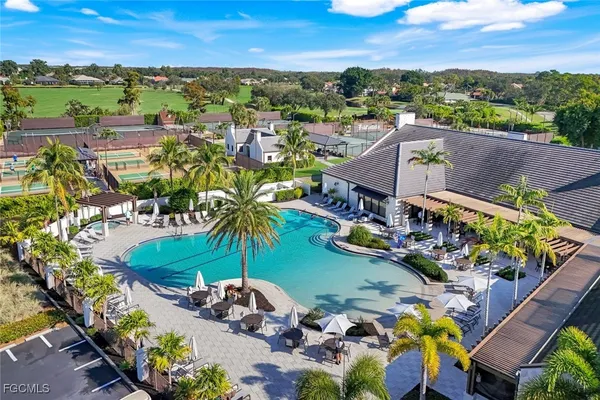 an aerial view of a house with a swimming pool yard and outdoor seating