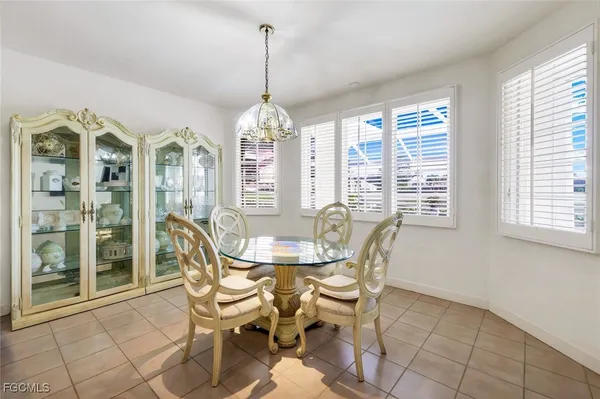 a view of a dining room with furniture wooden floor and chandelier