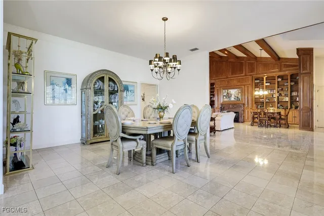 a dining room with furniture and a chandelier