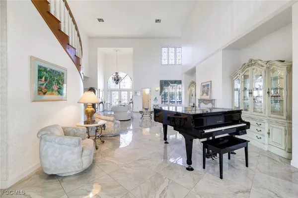 a living room with furniture and a dining table