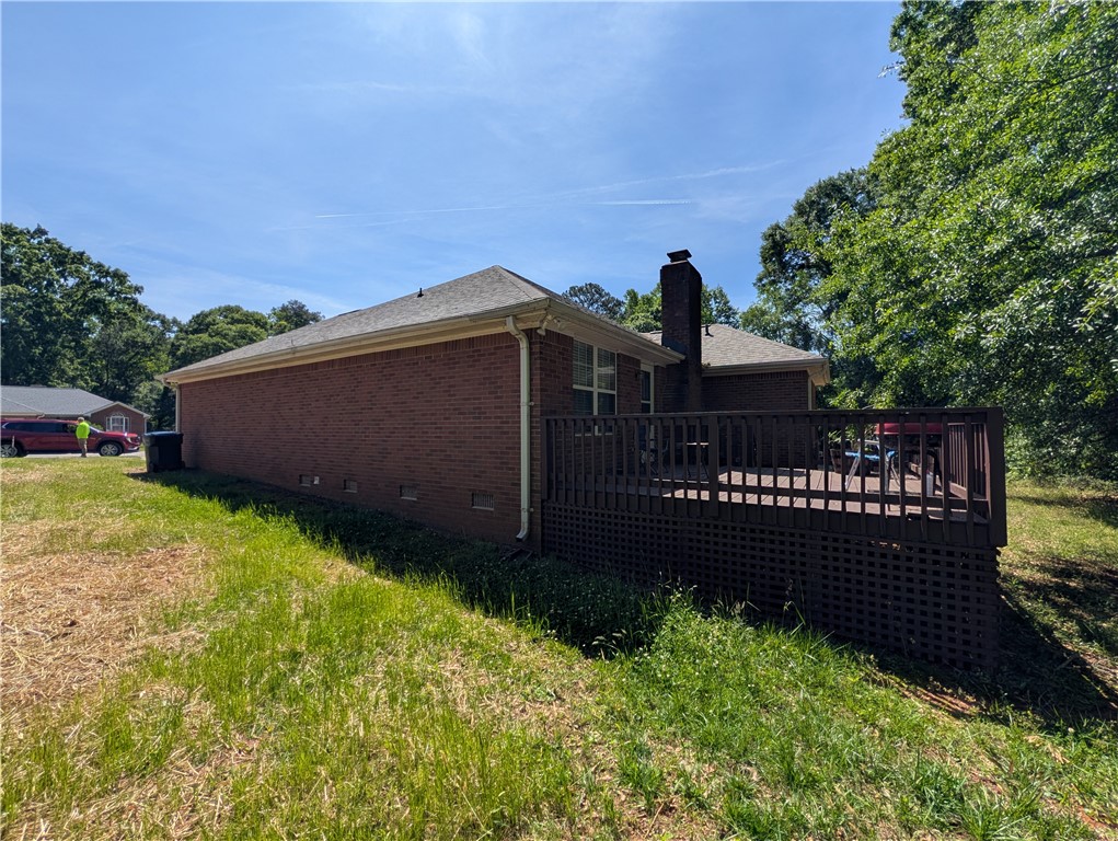 124 Woodbridge Court Anderson, SC 29621 - Photo 6 of 15 This residence features a brick exterior and a spacious outdoor deck, perfect for relaxation.
