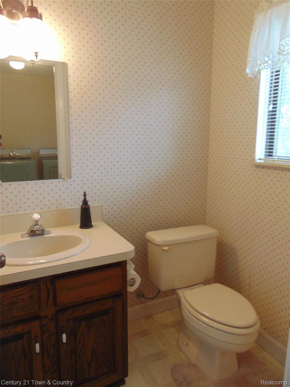 9555 Ridge Top Trail Clarkston, MI 48348 - Photo 23 of 49 Convenient Powder Room off the Laundry/Mud Room