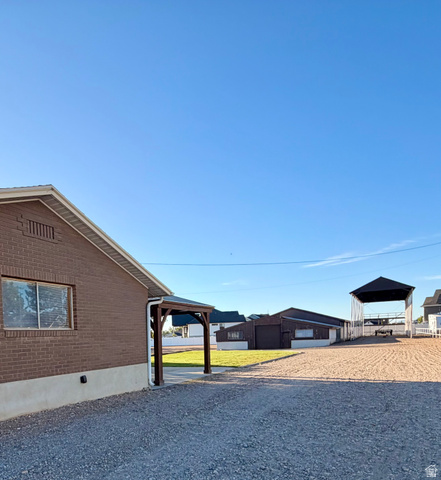2298 West 800 North Clinton, UT 84015 - Photo 4 of 53 Brick exterior with a covered entryway and gravel driveway