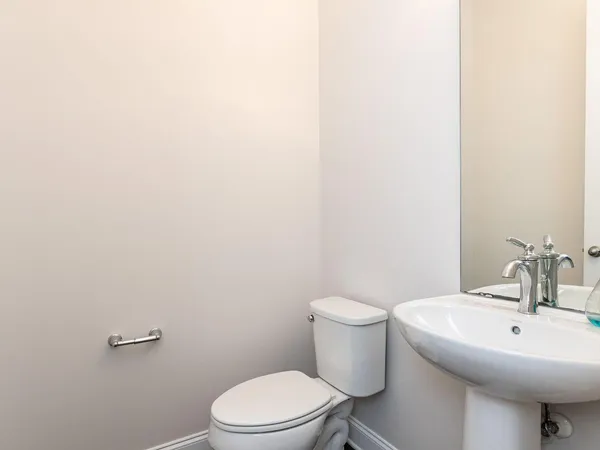 a white toilet sitting next to a white sink