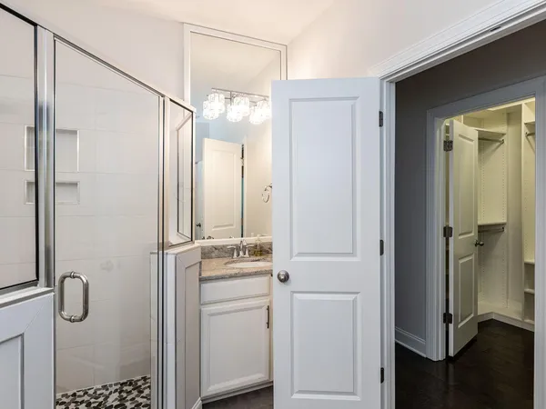 a bathroom with a shower a sink and a mirror