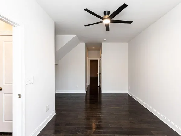 a view of empty room with wooden floor