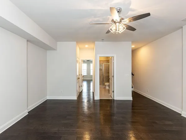 a view of an empty room with wooden floor
