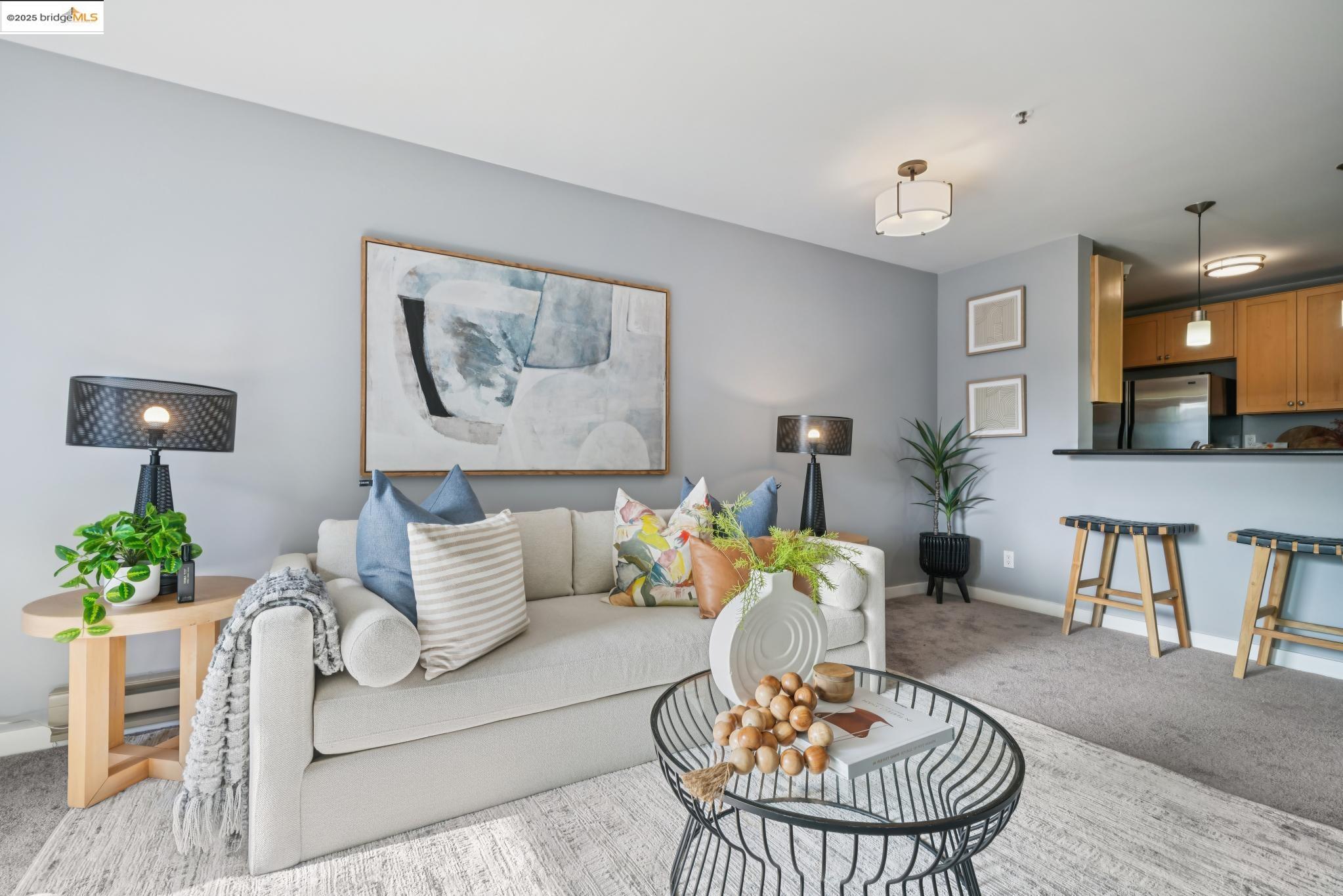 a living room with furniture and a dining table