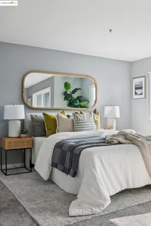 a bedroom with a bed and a painting on the wall