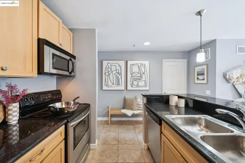 a kitchen with granite countertop a sink and a stove top oven