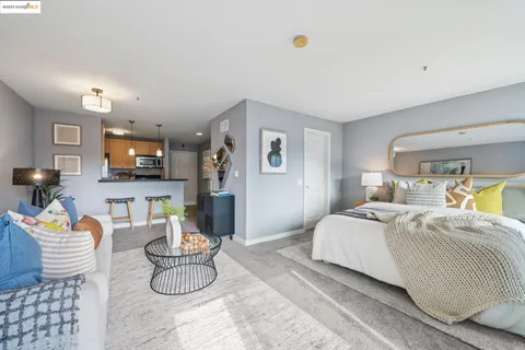 a bedroom with a bed a couch and potted plant