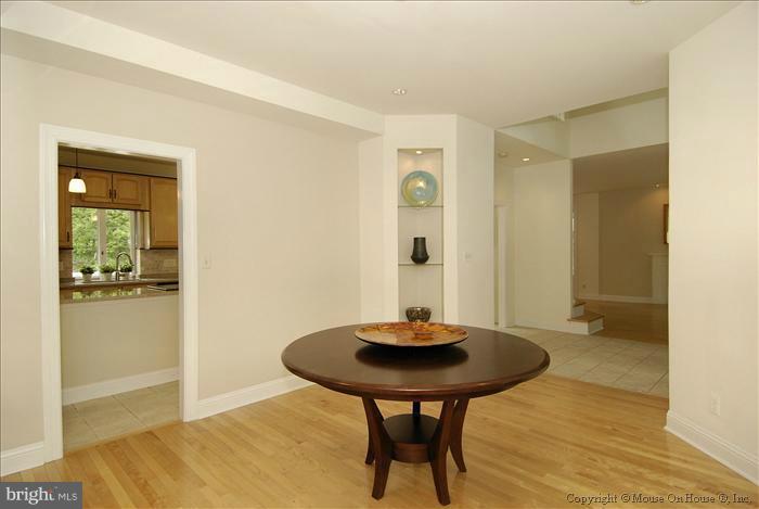 1716 Beulah Road Vienna, VA 22182 - Photo 14 of 30 a view of kitchen island with wooden floor dining table and chairs