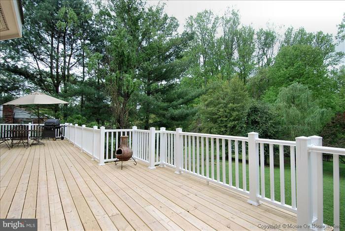 1716 Beulah Road Vienna, VA 22182 - Photo 3 of 30 a view of a wooden deck and a backyard with slide