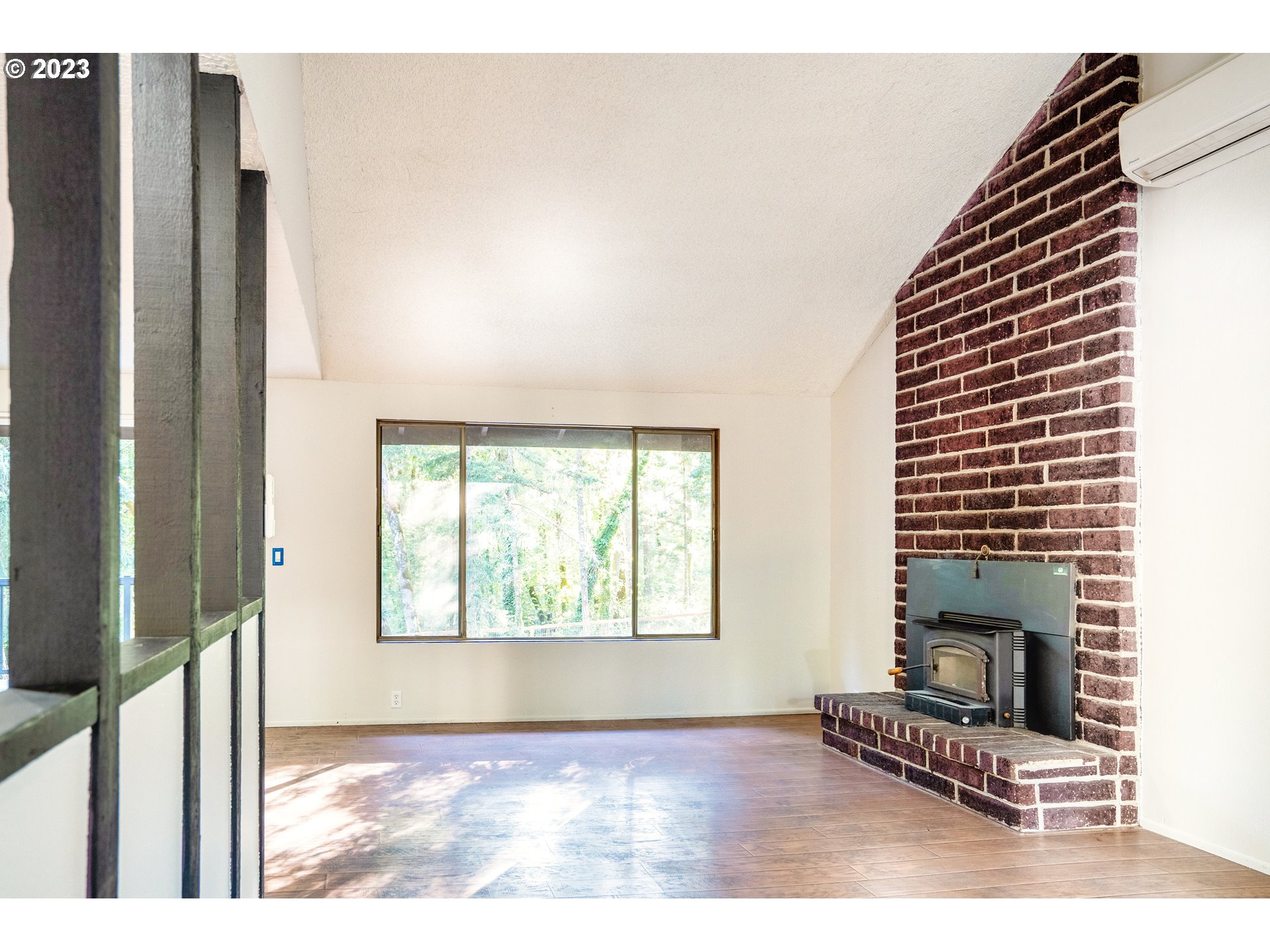 4146 Normandy Way Eugene, OR 97405 - Photo 14 of 48 a view of an empty room with a fireplace and a window