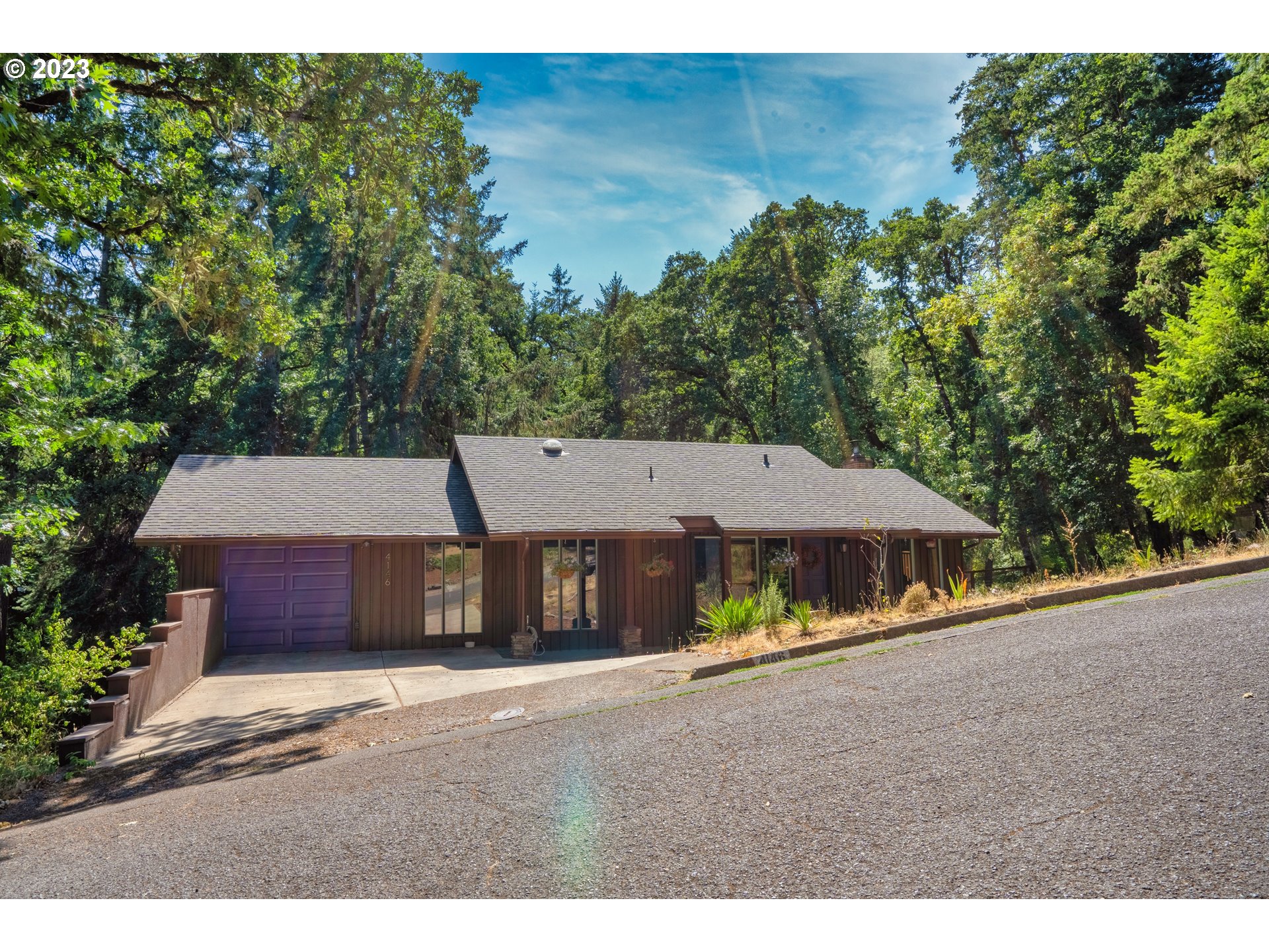 4146 Normandy Way Eugene, OR 97405 - Photo 2 of 48 a view of a house with a yard plants and large tree