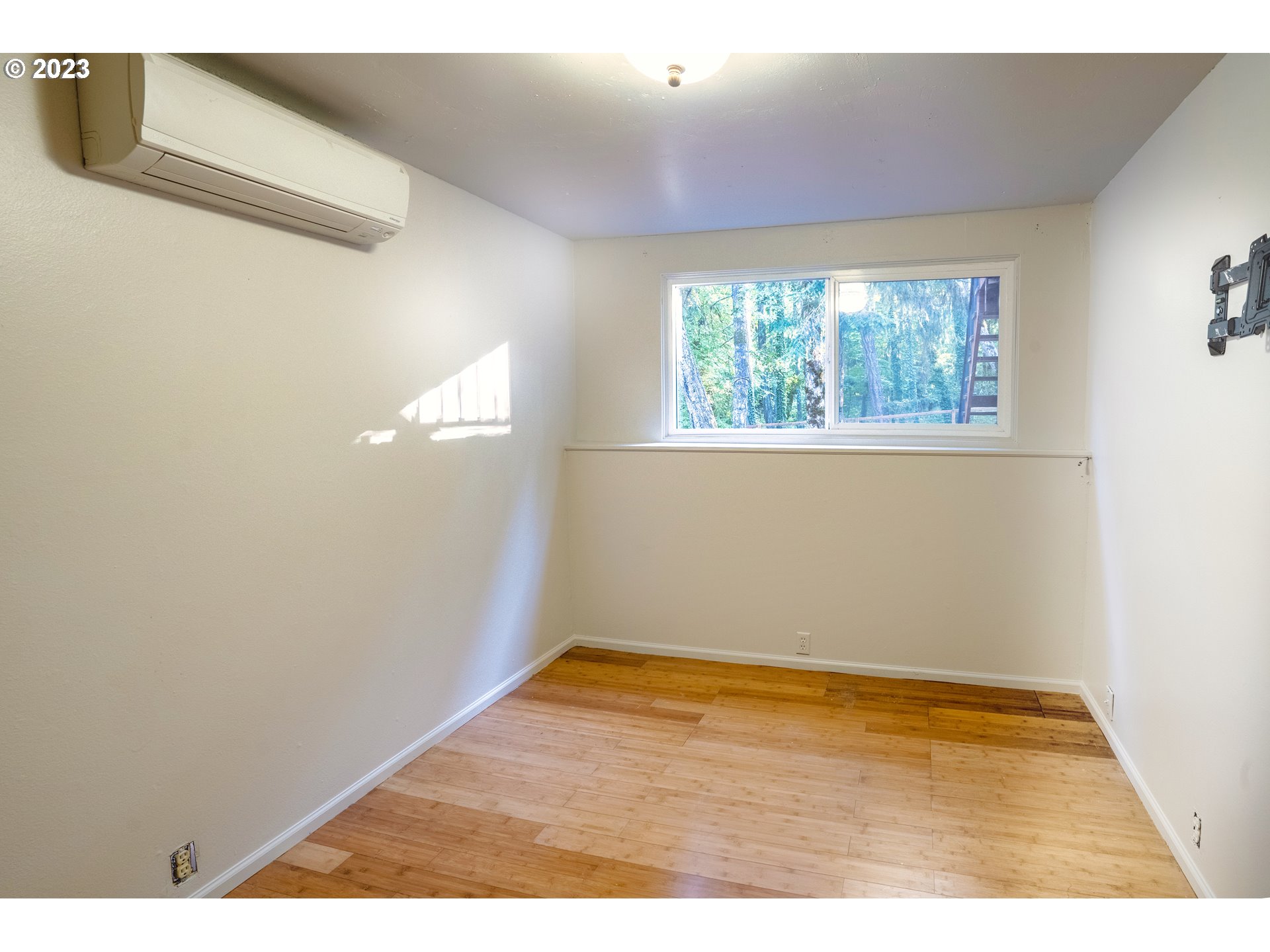 4146 Normandy Way Eugene, OR 97405 - Photo 27 of 48 a view of an empty room with wooden floor and a window