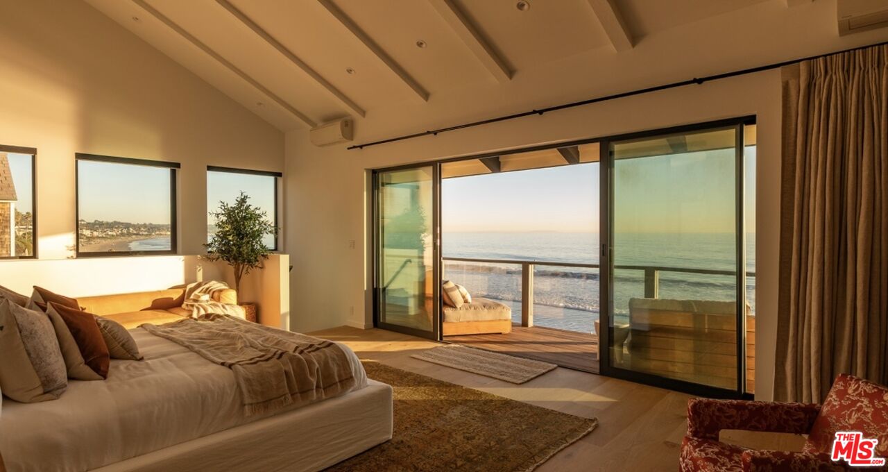 31376 Broad Beach Road Malibu, CA 90265 - Photo 20 of 32 a bedroom with a large bed and a large window