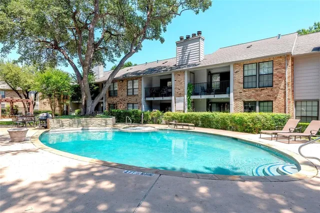 a view of a house with swimming pool and a porch