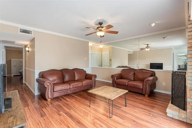 a living room with furniture a ceiling fan and a rug
