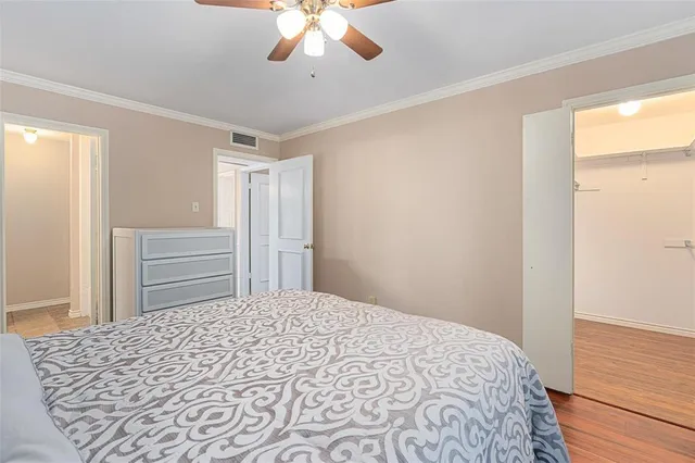 a bedroom with a large bed and a chandelier