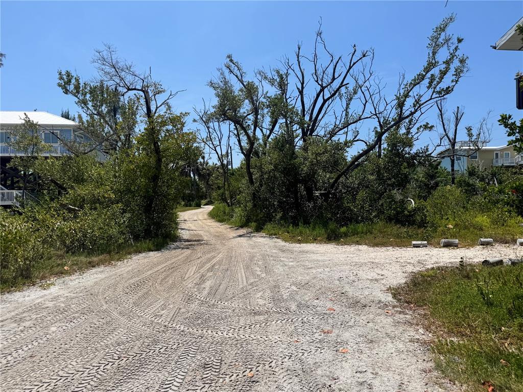 8992 Seagrape Lane Boca Grande, FL 33921 - Photo 17 of 28 a view of a dirt road with a building in the background