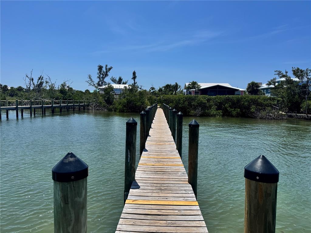 8992 Seagrape Lane Boca Grande, FL 33921 - Photo 25 of 28 a view of a lake with a large pool