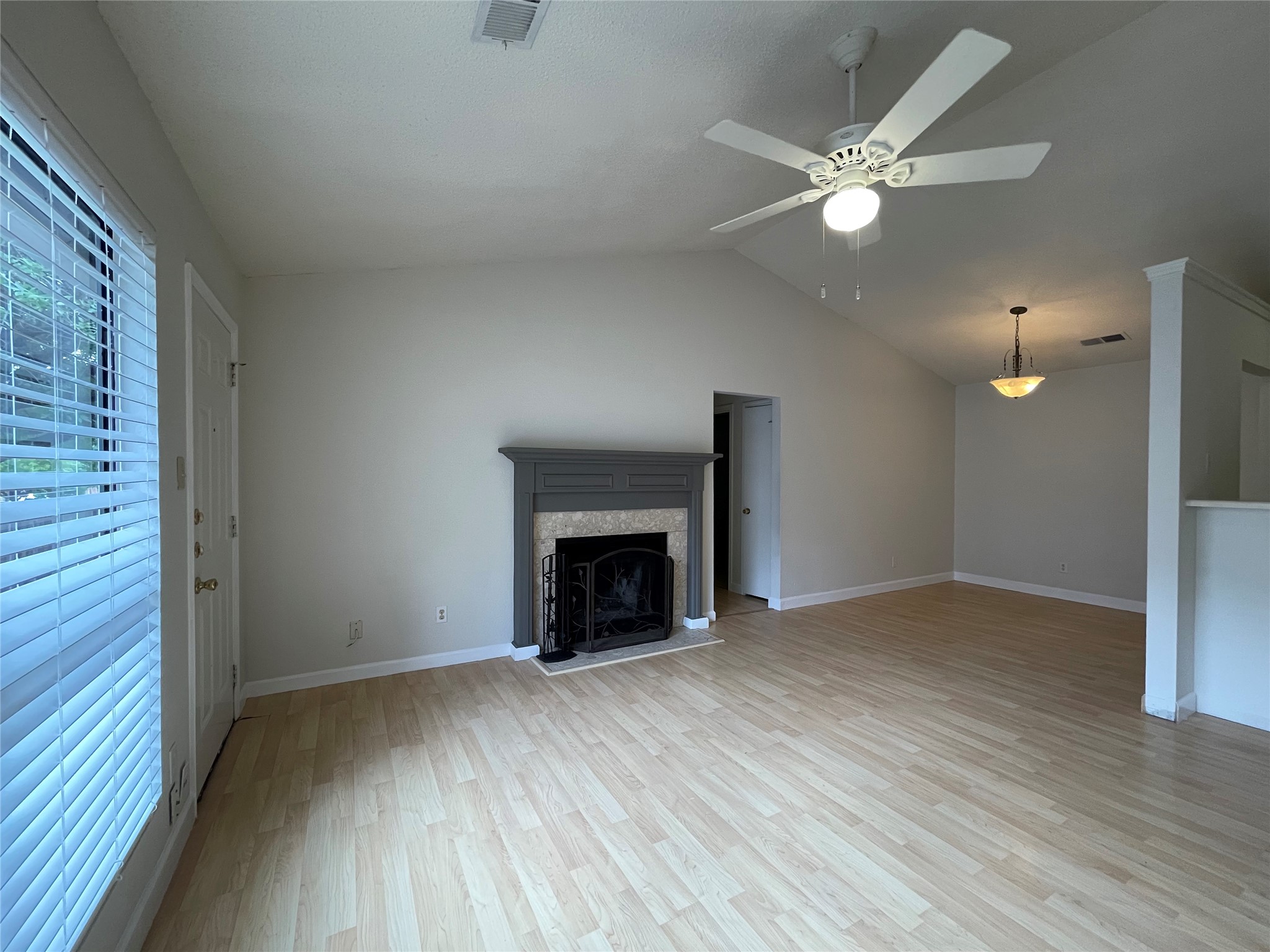 2031 Redwing Way Round Rock, TX 78664 - Photo 5 of 25 A living space with soaring vaulted ceilings and a classic fireplace, perfect for gatherings.