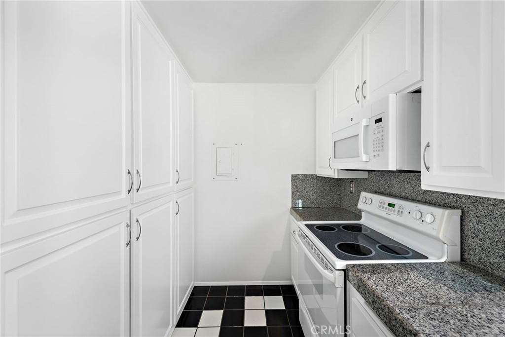 1707 West Balboa Boulevard, Unit A Newport Beach, CA 92663 - Photo 13 of 30 a kitchen with white cabinets and white appliances