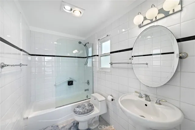 a view of a balcony with chairs and wooden fence