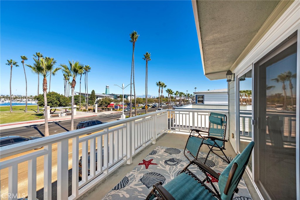 1707 West Balboa Boulevard, Unit A Newport Beach, CA 92663 - Photo 21 of 30 a view of a balcony with chairs and wooden fence
