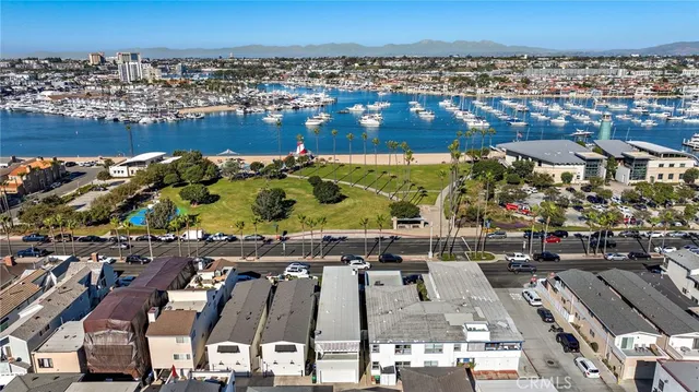 an aerial view of multiple houses with a ocean view