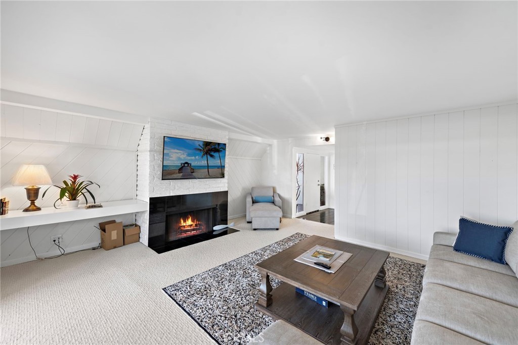 1707 West Balboa Boulevard, Unit A Newport Beach, CA 92663 - Photo 7 of 30 a living room with furniture and a fireplace