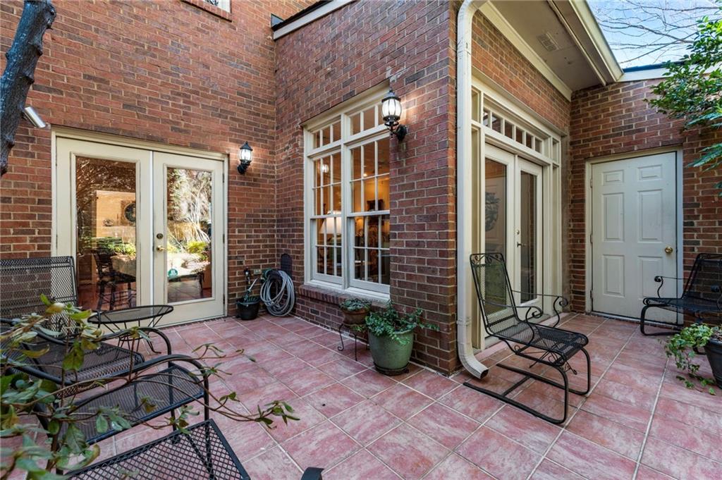 3127 Vinings Ridge Drive Southeast Atlanta, GA 30339 - Photo 12 of 33 a view of a brick house with chairs and table in a patio