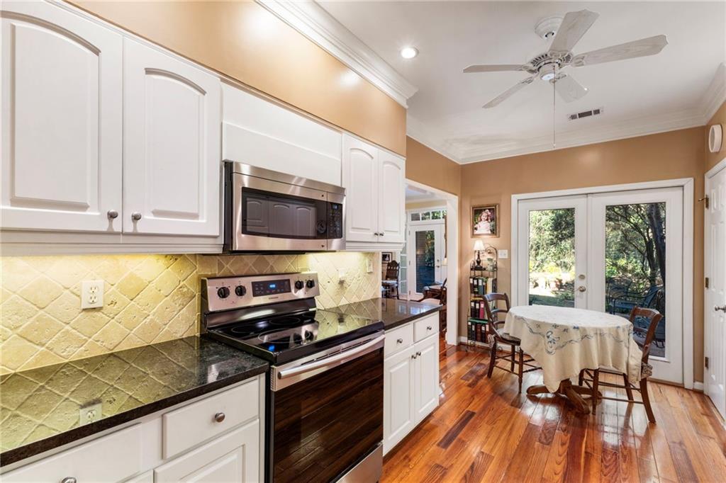 3127 Vinings Ridge Drive Southeast Atlanta, GA 30339 - Photo 19 of 33 a kitchen with stainless steel appliances wooden floors stove and cabinets