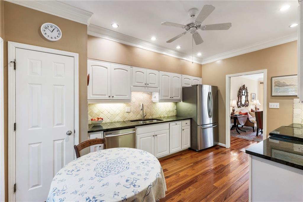 3127 Vinings Ridge Drive Southeast Atlanta, GA 30339 - Photo 3 of 33 a kitchen with stainless steel appliances kitchen island granite countertop a refrigerator a sink and dishwasher with a dining table