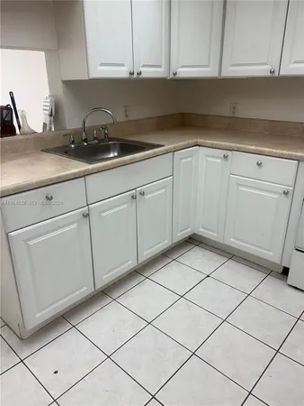 a kitchen with a sink and cabinets