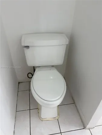 a white toilet sitting next to a white sink