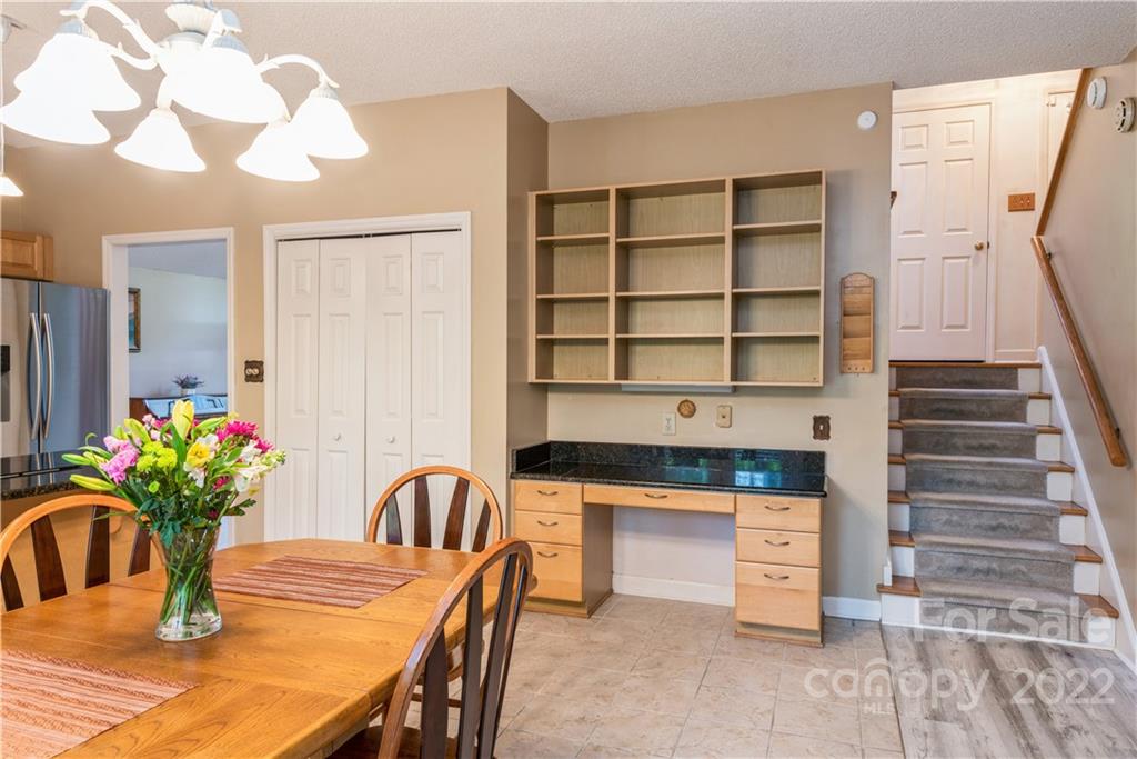 26050 Neptunes Landing Tega Cay, SC 29708 - Photo 11 of 39 a kitchen with granite countertop a table and chairs