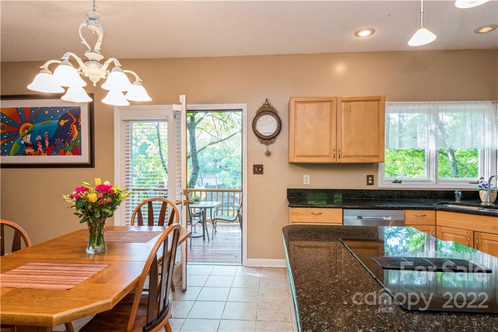 26050 Neptunes Landing Tega Cay, SC 29708 - Photo 12 of 39 a dining room with furniture a chandelier and wooden floor
