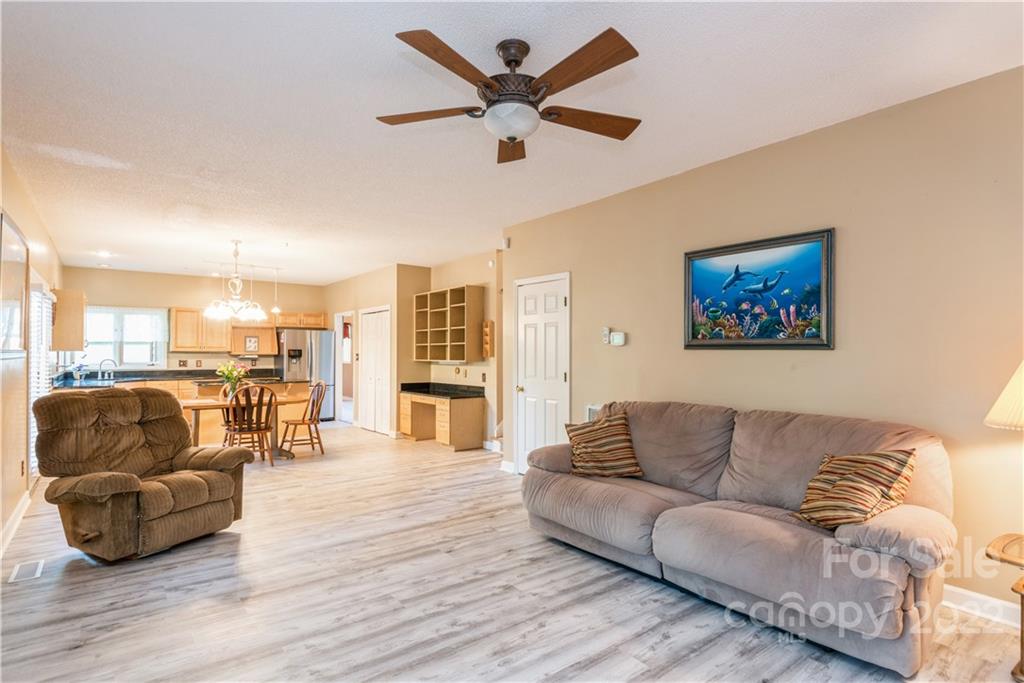 26050 Neptunes Landing Tega Cay, SC 29708 - Photo 14 of 39 a living room with furniture and a view of kitchen