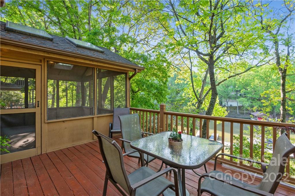 26050 Neptunes Landing Tega Cay, SC 29708 - Photo 18 of 39 a balcony with wooden floor table and chairs