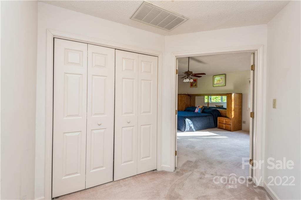 26050 Neptunes Landing Tega Cay, SC 29708 - Photo 21 of 39 a view of a room that has a mirror and furniture