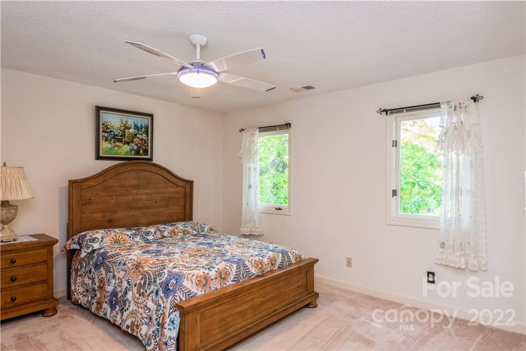 26050 Neptunes Landing Tega Cay, SC 29708 - Photo 26 of 39 a bedroom with a bed and a window