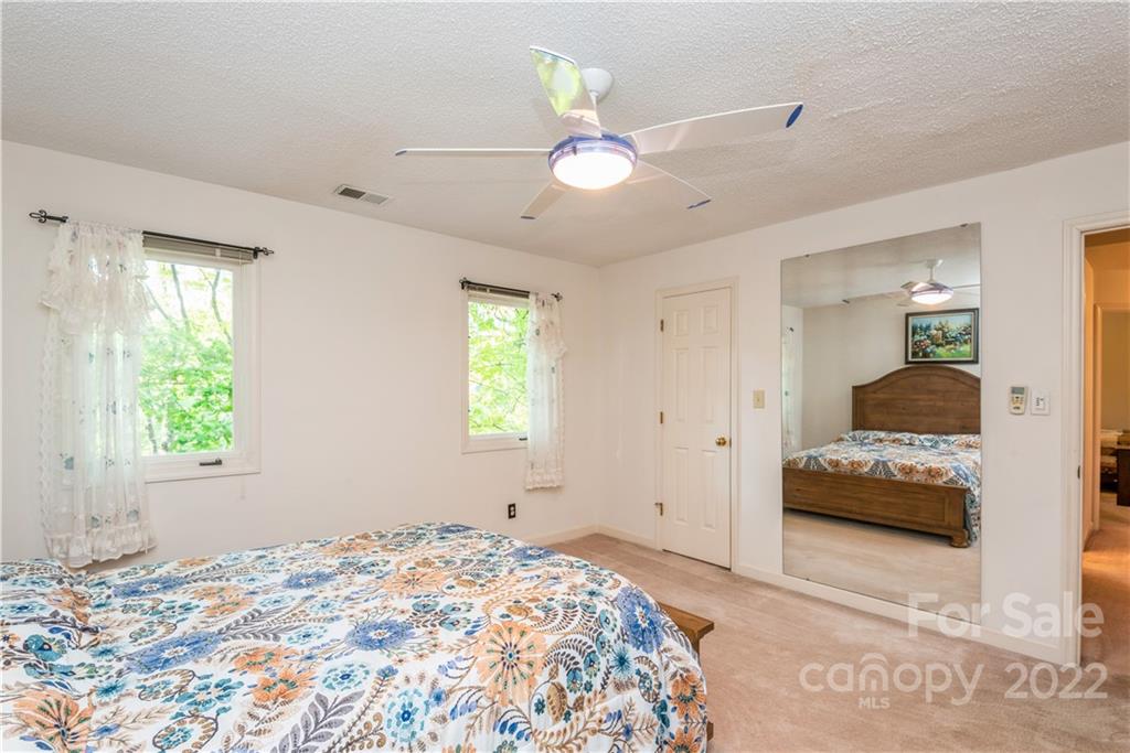 26050 Neptunes Landing Tega Cay, SC 29708 - Photo 27 of 39 a bedroom with a bed and a window