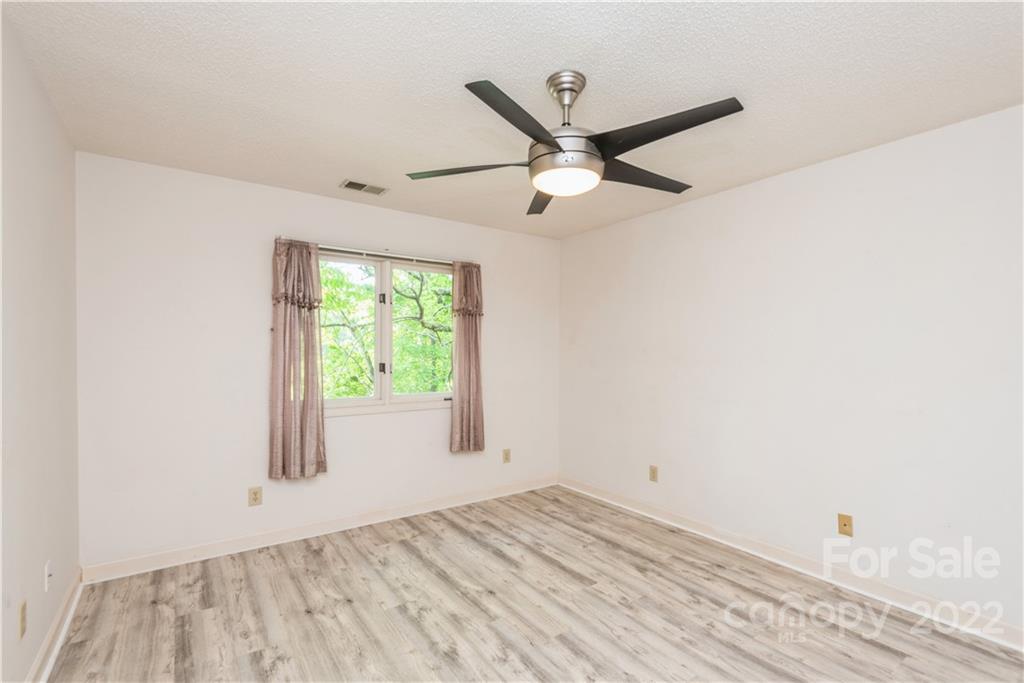 26050 Neptunes Landing Tega Cay, SC 29708 - Photo 30 of 39 a view of empty room with wooden floor and fan
