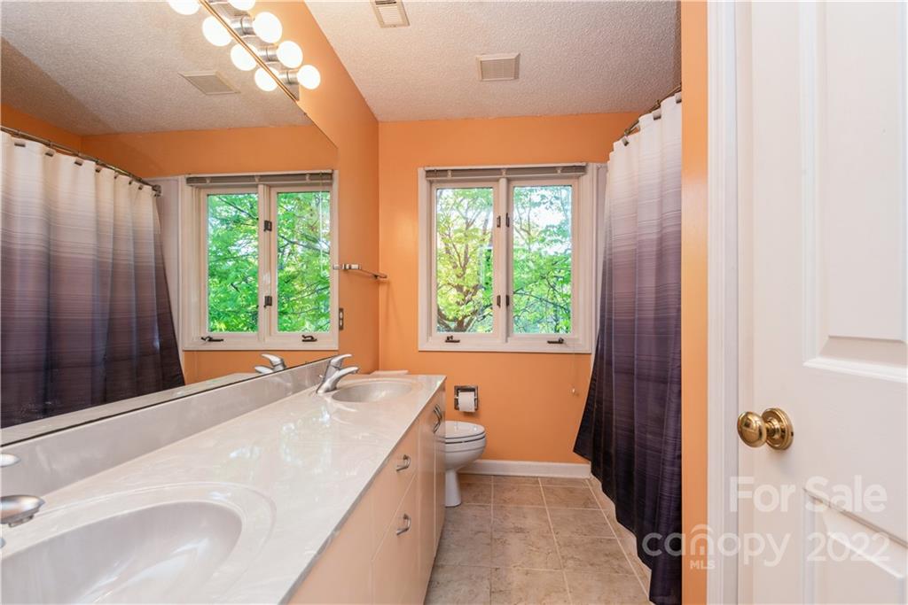 26050 Neptunes Landing Tega Cay, SC 29708 - Photo 31 of 39 a bathroom with a sink and a large mirror