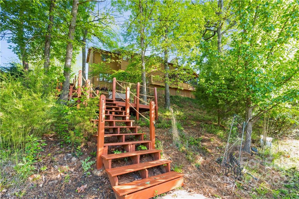 26050 Neptunes Landing Tega Cay, SC 29708 - Photo 36 of 39 a view of wooden house with a yard