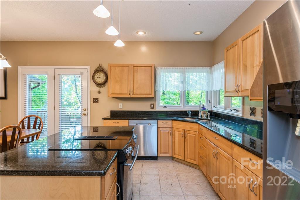 26050 Neptunes Landing Tega Cay, SC 29708 - Photo 9 of 39 a kitchen with granite countertop a sink and a stove
