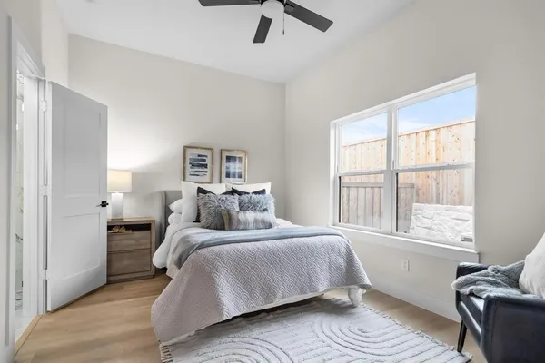 a bedroom with a bed and glass window