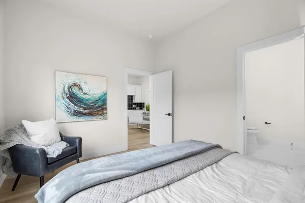 a bedroom with a bed and a couch
